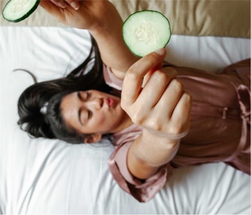 girl relaxing holding cucumbers