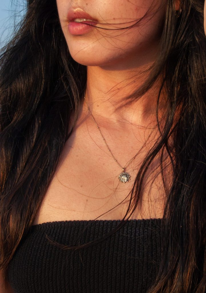 Girl wearing a simple summer gold necklace